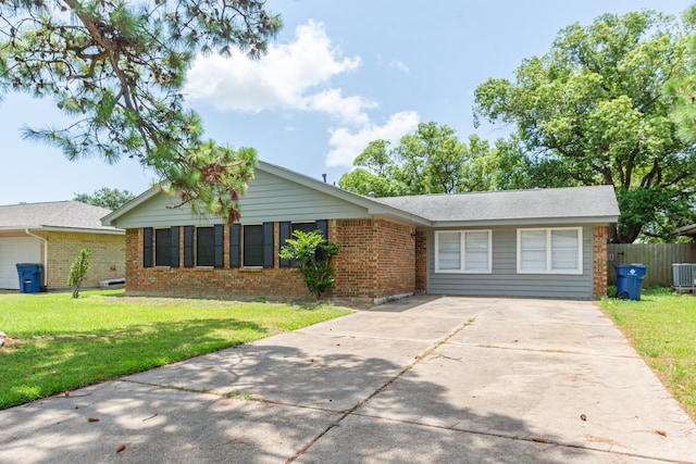 ranch-style home featuring cooling unit and a front yard