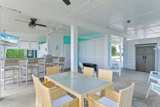 view of patio / terrace with ceiling fan and exterior bar