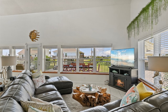 living room featuring a towering ceiling and light tile patterned floors