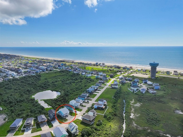 bird's eye view featuring a water view and a view of the beach