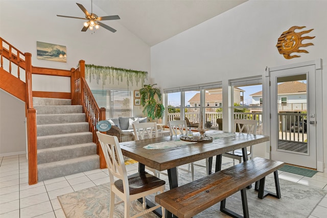 dining room featuring light tile patterned flooring, ceiling fan, and high vaulted ceiling