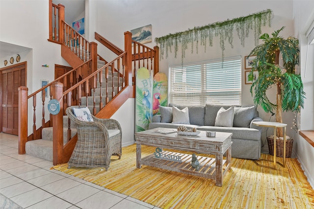 living room with light hardwood / wood-style floors and a high ceiling