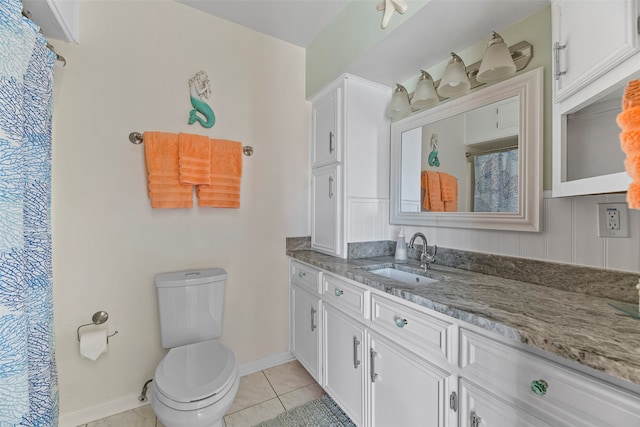 bathroom featuring tile patterned flooring, vanity, and toilet