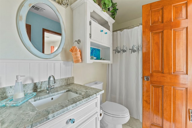 bathroom featuring vanity, toilet, and tile patterned flooring