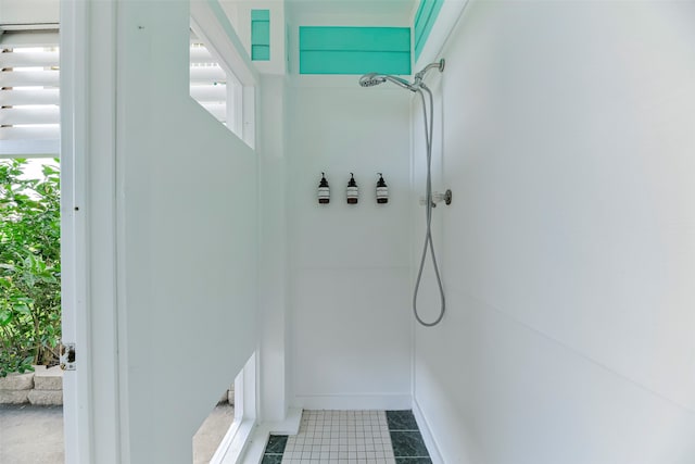 bathroom with tile patterned floors and walk in shower