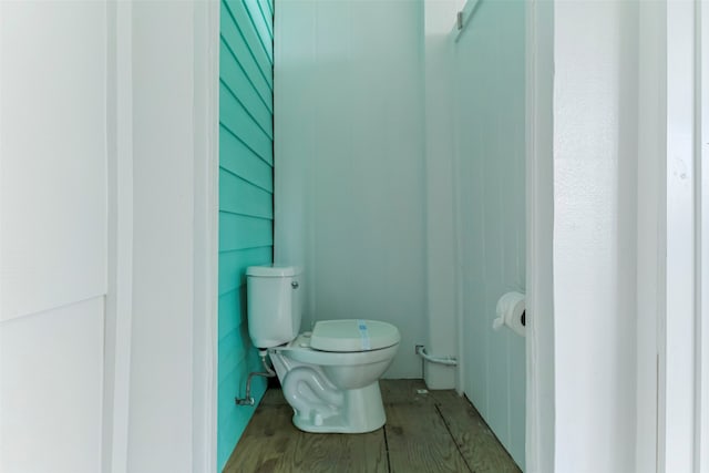 bathroom with toilet and hardwood / wood-style floors