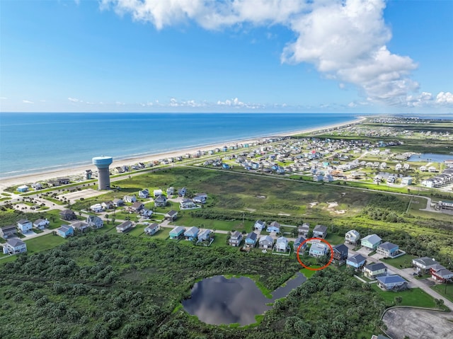 aerial view with a water view and a view of the beach