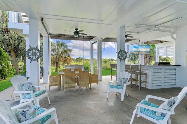 view of patio / terrace featuring a bar and ceiling fan