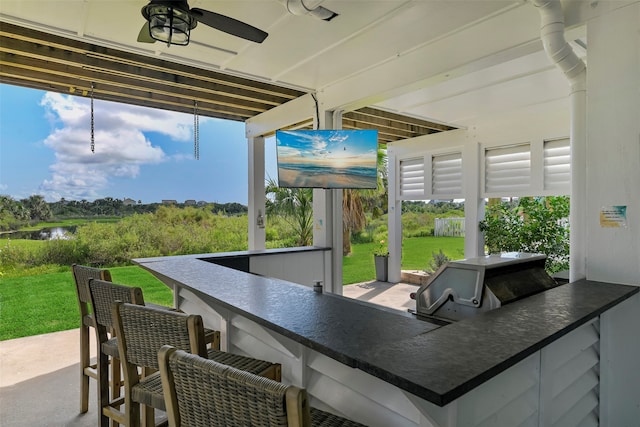 sunroom featuring plenty of natural light and ceiling fan