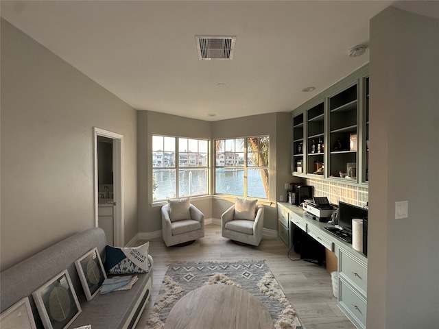 living room with light wood-type flooring and sink