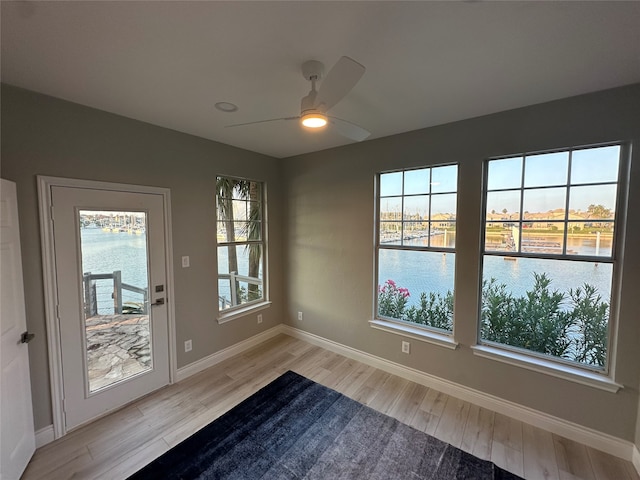 doorway to outside with ceiling fan and light hardwood / wood-style floors