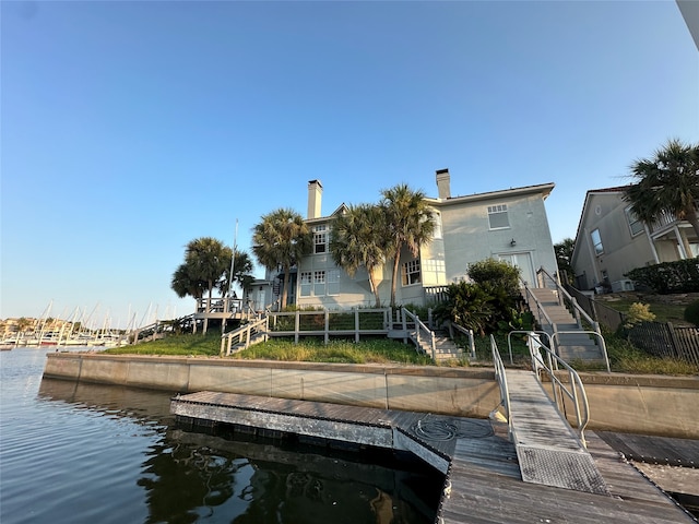 rear view of house featuring a water view