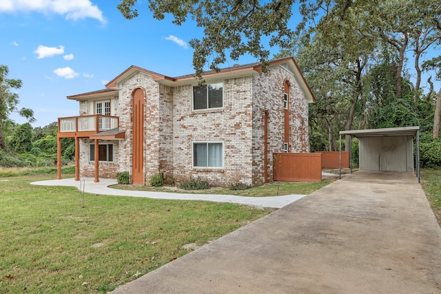 view of front of property featuring a balcony, a front lawn, and a carport