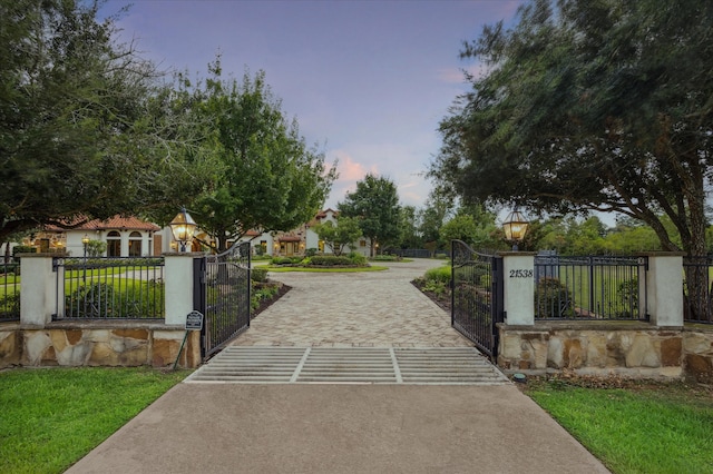 gate at dusk with a yard