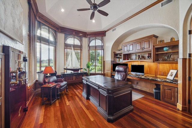 office space with ceiling fan, visible vents, wood finished floors, and built in study area