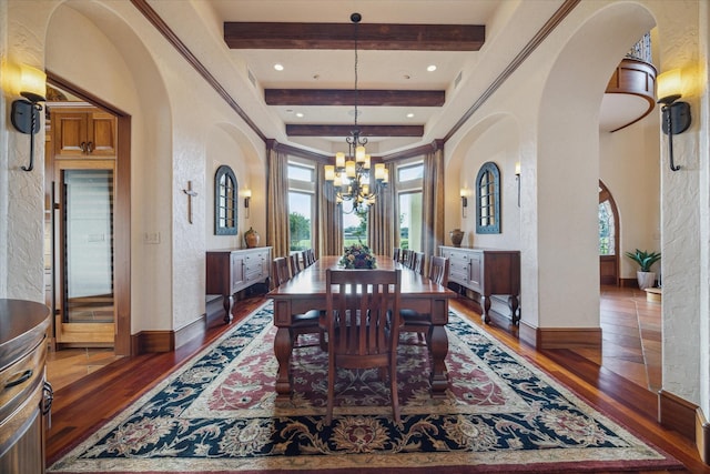 dining room featuring wood-type flooring, arched walkways, beamed ceiling, and plenty of natural light