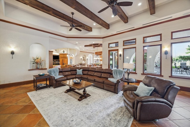 living room with arched walkways, a ceiling fan, beam ceiling, and a wealth of natural light