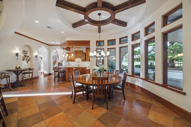 dining room featuring a notable chandelier, arched walkways, recessed lighting, baseboards, and coffered ceiling