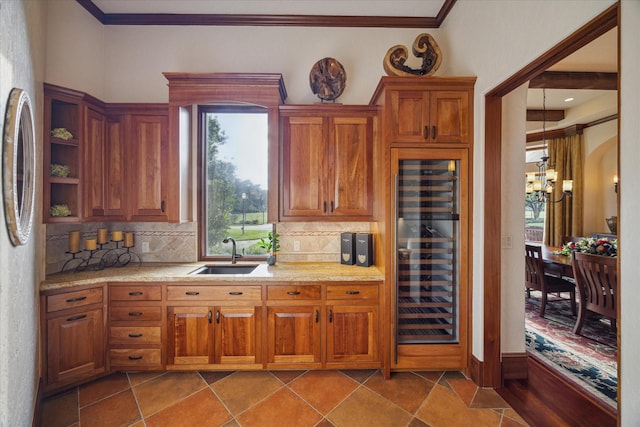 kitchen featuring light countertops, beverage cooler, a wealth of natural light, and a sink