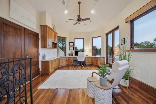 office area with a healthy amount of sunlight, ceiling fan, wood finished floors, and visible vents