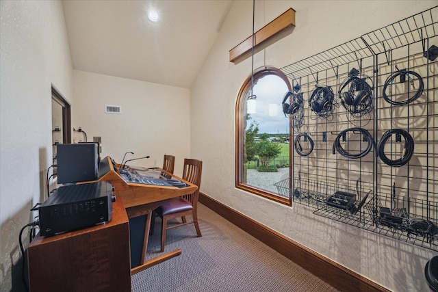 carpeted home office with baseboards, visible vents, and lofted ceiling