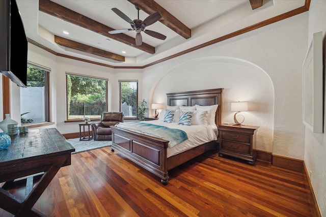 bedroom with baseboards, beamed ceiling, a ceiling fan, and wood finished floors