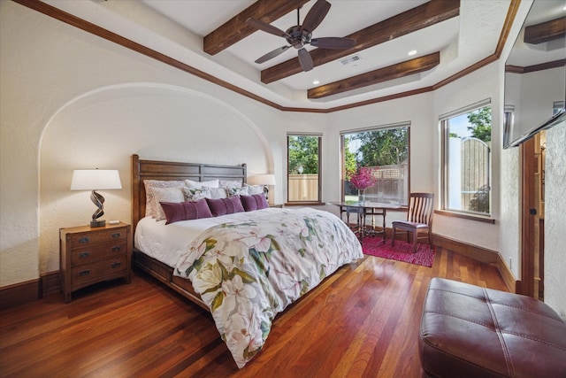 bedroom featuring baseboards, visible vents, beam ceiling, and wood finished floors