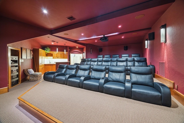 cinema featuring recessed lighting, beamed ceiling, light colored carpet, and visible vents