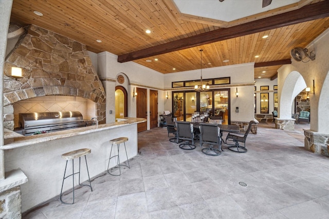 view of patio / terrace featuring french doors, area for grilling, exterior kitchen, outdoor wet bar, and outdoor dining space