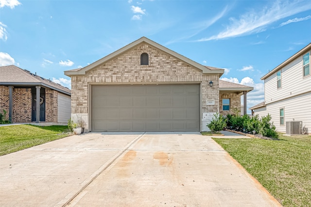 view of front of home featuring a garage, a front lawn, and central air condition unit