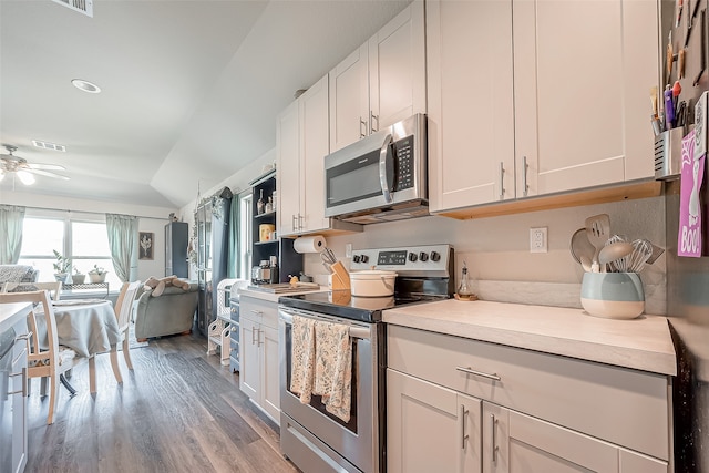 kitchen with white cabinets, ceiling fan, stainless steel appliances, and light hardwood / wood-style flooring