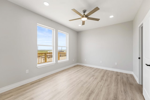 spare room featuring ceiling fan and light hardwood / wood-style flooring