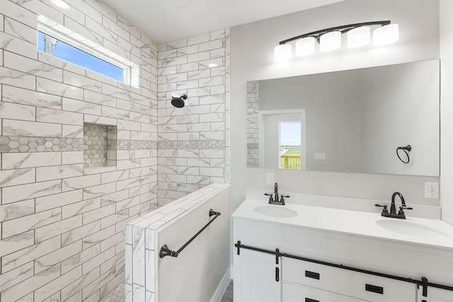 bathroom featuring vanity, tiled shower, and a wealth of natural light