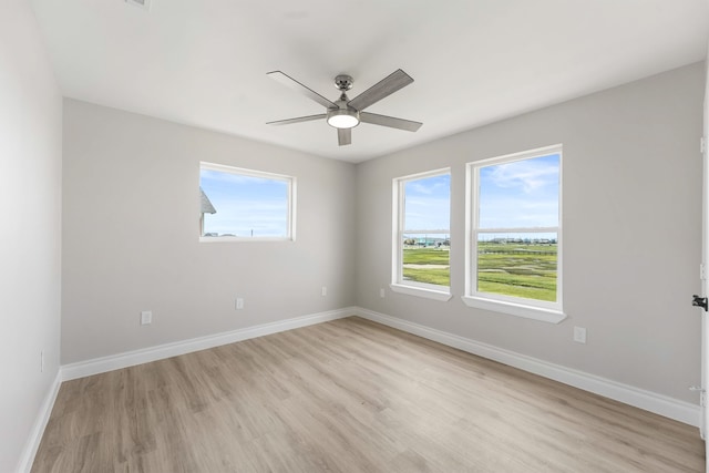 empty room with light hardwood / wood-style flooring and ceiling fan