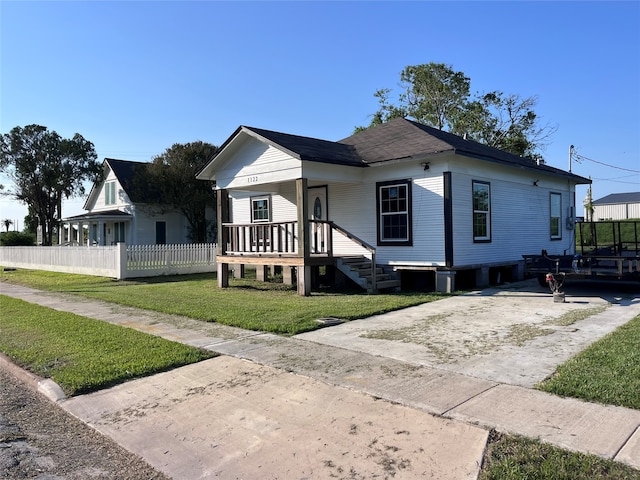 bungalow-style home with a front yard