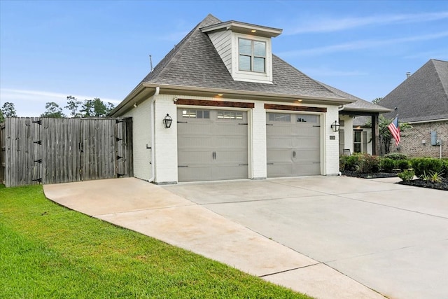 exterior space with a garage and a lawn