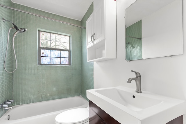 full bathroom with vanity, tiled shower / bath combo, and toilet