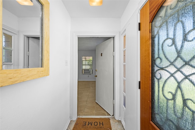 corridor with cooling unit and light tile patterned flooring