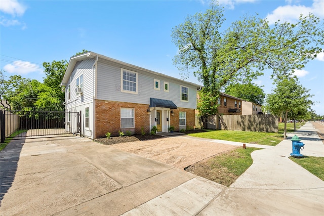 view of front of home featuring cooling unit and a front yard