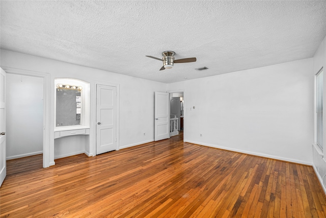 unfurnished bedroom featuring wood-type flooring, ceiling fan, and a textured ceiling