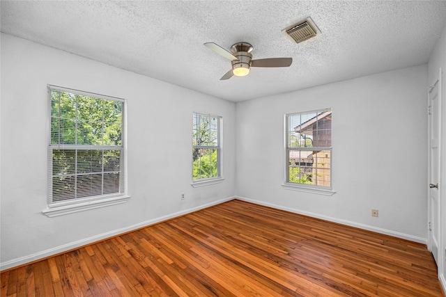 unfurnished room with ceiling fan, hardwood / wood-style floors, and a textured ceiling