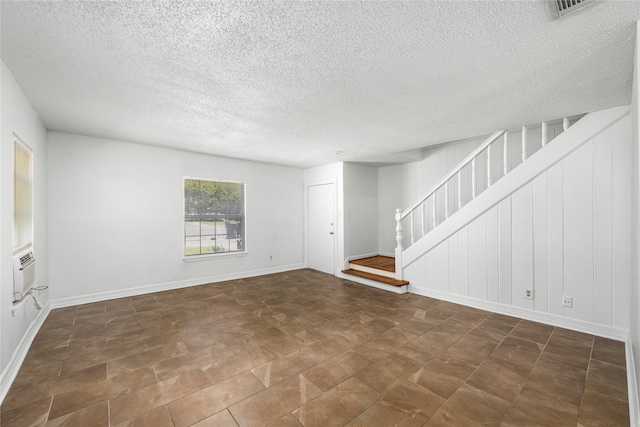 unfurnished living room featuring a textured ceiling