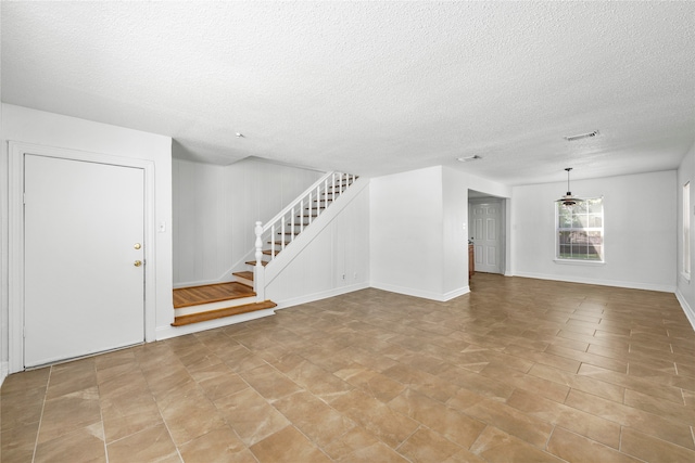 unfurnished living room with a textured ceiling