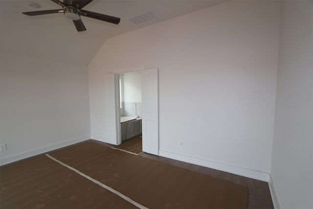 unfurnished bedroom featuring ceiling fan, vaulted ceiling, dark hardwood / wood-style floors, and connected bathroom