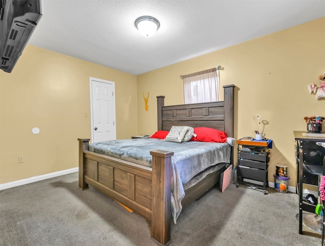 bedroom featuring carpet floors and a textured ceiling