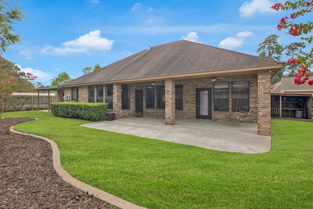 rear view of property with a patio and a yard