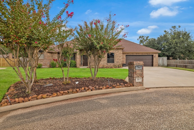 view of front of property featuring a garage and a front yard