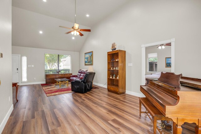 living room featuring ceiling fan, hardwood / wood-style flooring, and high vaulted ceiling