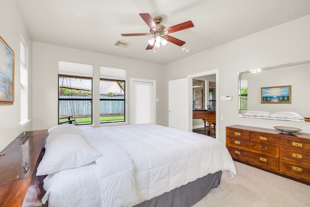 bedroom with light carpet and ceiling fan