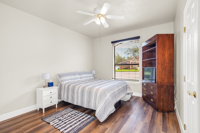 bedroom with ceiling fan and dark hardwood / wood-style flooring